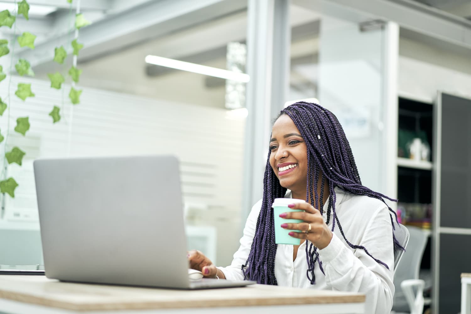 Woman working while drinking coffee